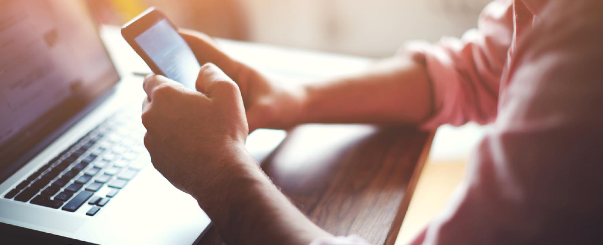 Man Typing on Lap Top