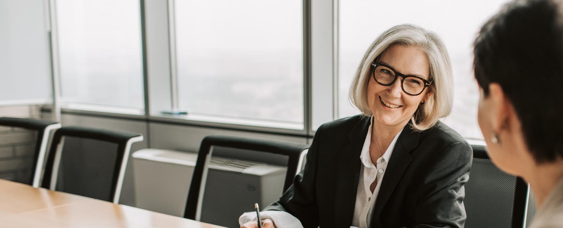 Two business women in boardroom discussion