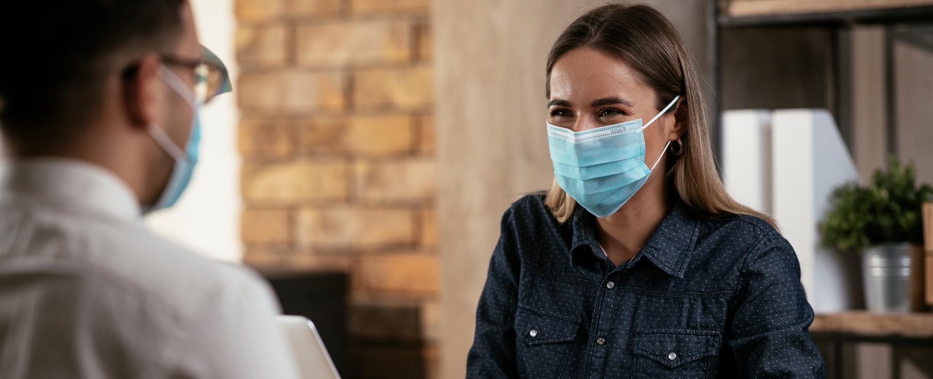 Woman wearing mask having a conversation