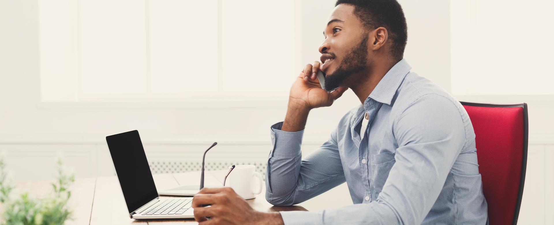 Man talking on phone at desk