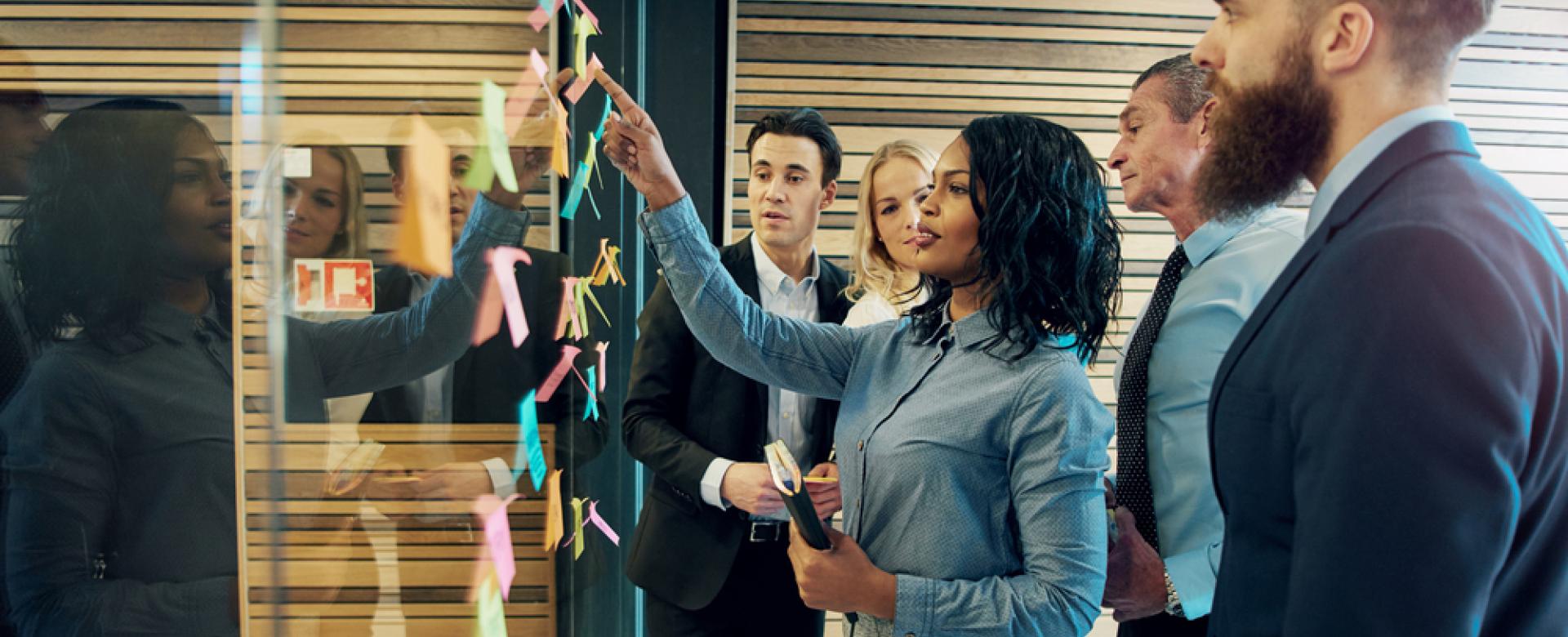 People strategizing on a board