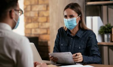 Woman wearing mask having a conversation