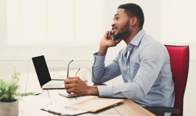 Man talking on phone at desk