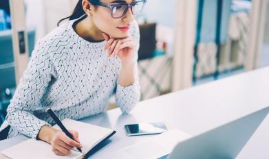 Woman writing in notebook