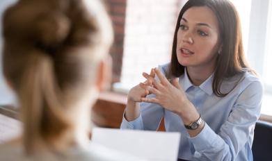 women talking across a table