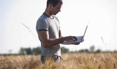 Worker on laptop in field