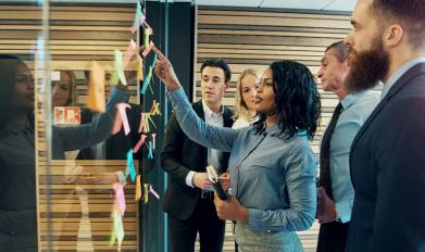 People strategizing on a board