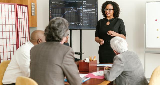 A business women presenting for colleagues