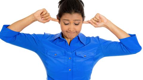 girl blocking ears